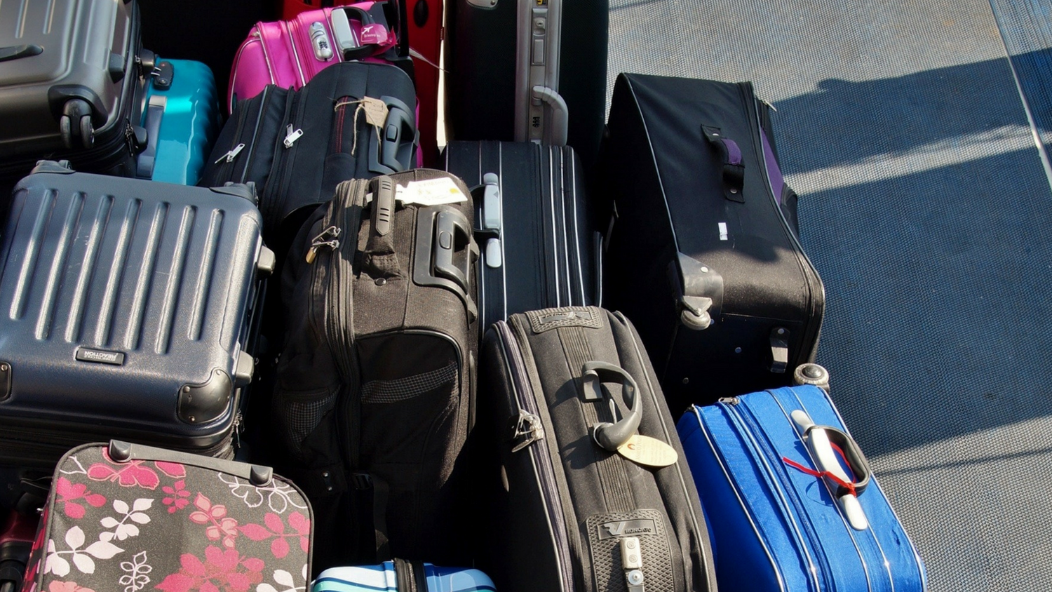 Pile of suitcases on ground
