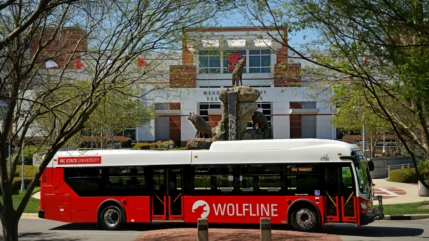 Wolfline bus with Wendell H. Murphy Football Center in background